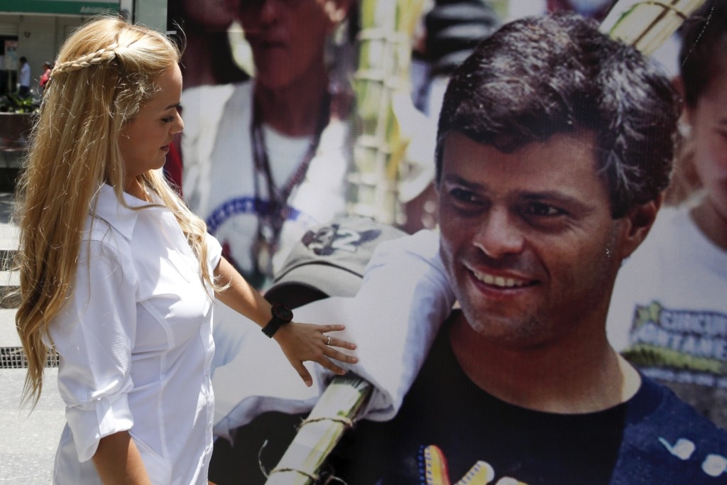 Lilian Tintori, wife of Venezuela's jailed opposition leader Leopoldo Lopez, looks at and touches a picture of him, during a gathering to celebrate the birthday of her husband in Caracas April 29, 2015. REUTERS/Carlos Garcia Rawlins