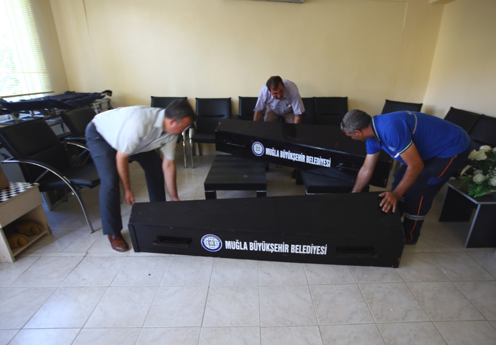 Officials carry the coffins of Syrian migrants who were washed up drowned on a beach near Turkish resort of Bodrum on Wednesday, from a morgue to a funeral car in Mugla, Turkey, Thursday, Sept. 3, 2015. Images of Aylan’s body on the beach, have heightened global attention to a wave of migration, driven by war and deprivation, that is unparalleled since World War II. (AP Photos/Emrah Gurel)
