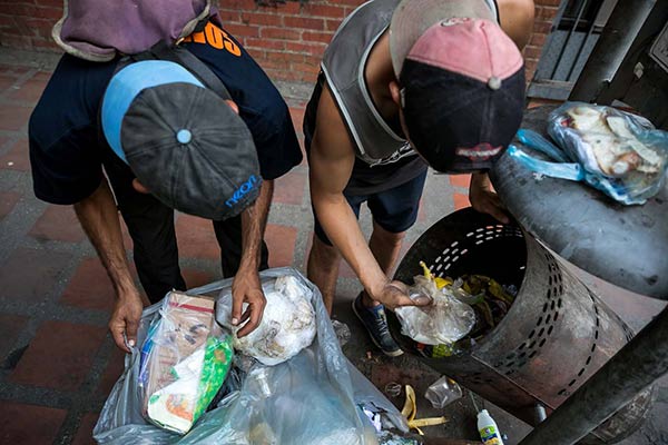 Niños buscan comida en la basura |Foto: EFE
