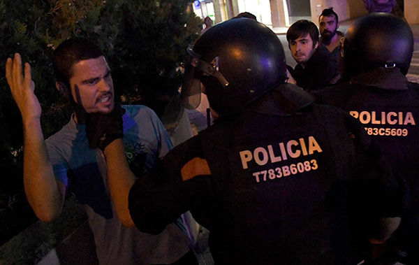 Un grupo de manifestantes se enfrenta a los agentes durante una operación relacionada con el referéndum idependentista de Cataluña en Terrassa, el 19 de septiembre de 2017. Foto:  Lluis Gene / AFP